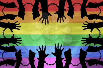 Discrimination against gay concept. Silhouette gay hands in handcuffs on the background of the rainbow