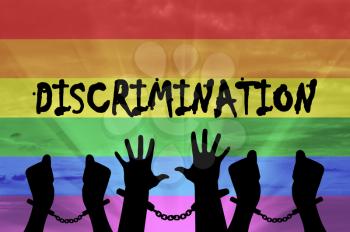 Discrimination against gay rights. Silhouette of hands in handcuffs on the background of the rainbow
