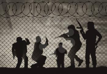 Terrorism concept. Terrorist attack on civilians near the fence of barbed wire