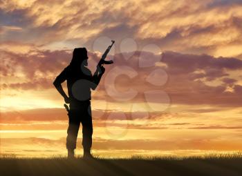 Terrorism and conflict. Armed terrorists on the sunset background