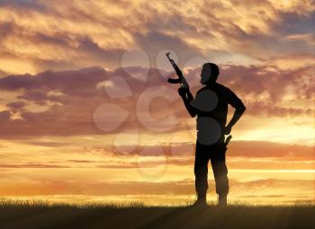 Terrorism and conflict. Armed terrorists on the sunset background