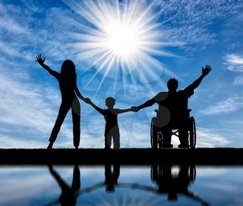 Happy disabled person in wheelchair with his family holding hands and reflection in water in afternoon. Concept happy disabled and family
