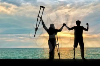 Disabled person with prosthesis and crutches near sea holding hands. Concept disabled