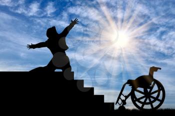  Concept of disability and positive. Silhouette of disabled person to experience happiness at the top of the stairs daytime