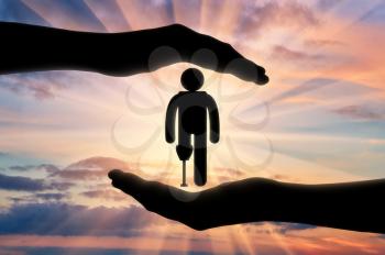 Icon is disabled with prosthesis in hands on sunset background. Concept protection of people with disabilities