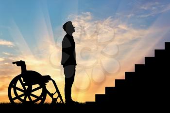 Concept of disability and disease. Silhouette of disabled person in front of the stairs at sunset