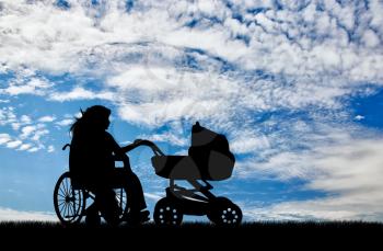 Disabled woman in wheelchair holding baby carriage on background of sky. Concept disabled and family