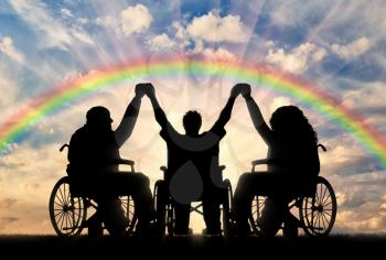 Disabled in wheelchair on rainbow background holding hands. Concept happy disabled