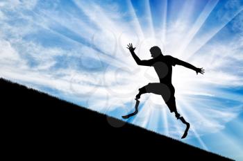 Disabled runner with prosthetic legs to rise up against the sky. Concept disability and sport