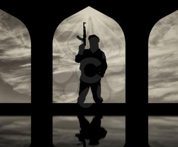 Concept of terrorism. Silhouette of a terrorist with a gun in a building and reflection