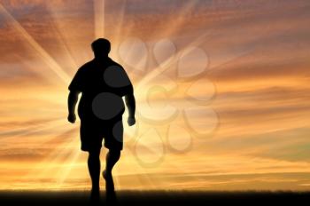 Fat man walks on nature sunset. Obesity concept