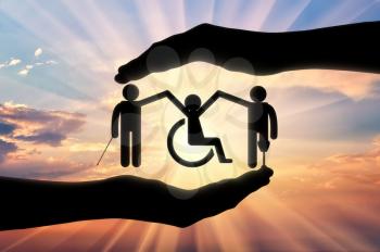 Disabled society to hold hands in handbreadth against backdrop sunset. Concept help disabled persons