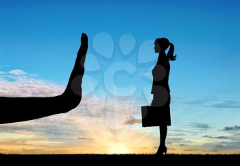 Discrimination and racism concept. Silhouettes of hands stop woman on the sunset background