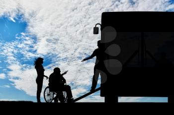 Disabled person in wheelchair to help climb the ramp in bus day. Concept help disabilities