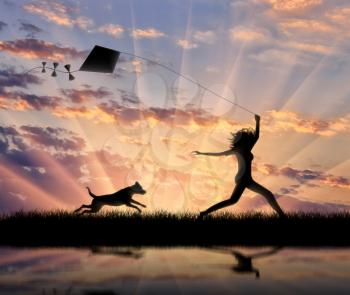 Silhouette girl sunset launch kite and runs with her dog. Concept friendship and game