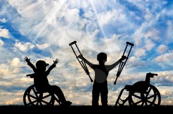 Boy in wheelchair and disabled boy standing with crutches day. Happy disabled child concept