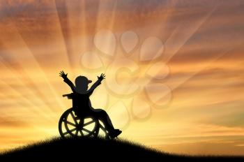 Happy boy in wheelchair on hill sunset. Concept happy child disabled