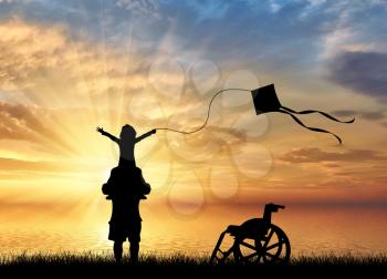 Happy disabled child on shoulders of dad playing with kite and wheelchair near sea sunset. Disabled children concept
