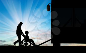 Dad helps disabled child in wheelchair to climb the ramp in bus. Concept help child disabilities