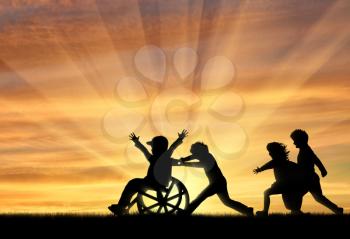 Happy boy in wheelchair playing with children sunset. Concept happy child disabled