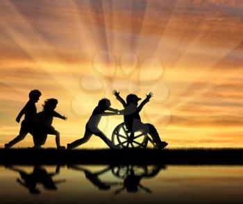Happy boy in wheelchair playing with children and their reflection in water sunset. Concept happy child disabled