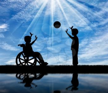 Happy boy in a wheelchair playing with boy in ball and reflection in water