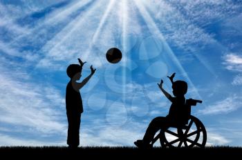 Boy in wheelchair playing with boy in ball day. Concept happy child disabled