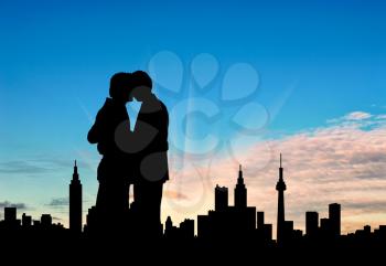 Concept of gay people. Silhouette happy gay kiss against a beautiful sky and city in the distance