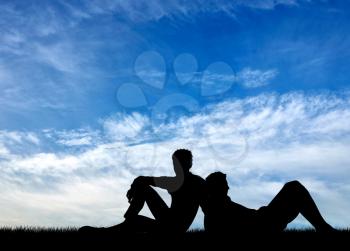 Concept of gay people. Silhouette of two gay men resting against the blue sky