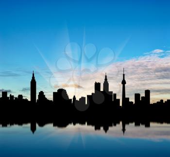 Cityscape silhouette on a background of beautiful sunrise and the river