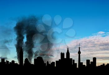 Silhouette of the city in a smoke on a background of beautiful sky