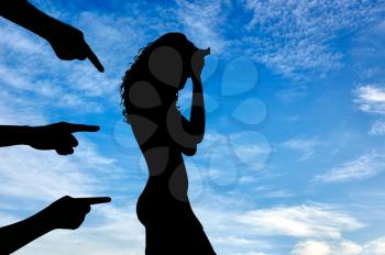 Concept of deceit and betrayal. Silhouette of a woman and condemning the hands of people against the sky