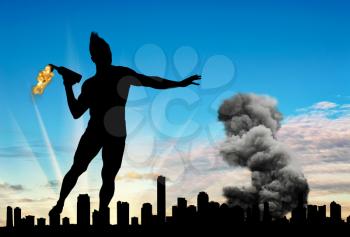 Concept of military conflict. Silhouette of a man throwing a Molotov cocktail against the background of the city in smoke