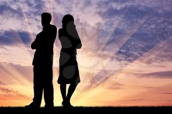 Concept of betrayal and treason. Silhouette of man and woman in a quarrel at sunset