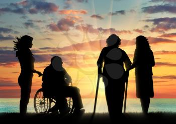 Silhouette of two people with disabilities and peepers. Disabled man in a wheelchair and a woman on crutches and peepers near sea