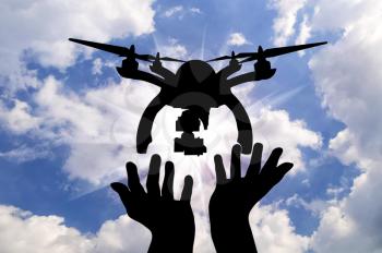 Silhouette takeoff drone of human hands against the sky