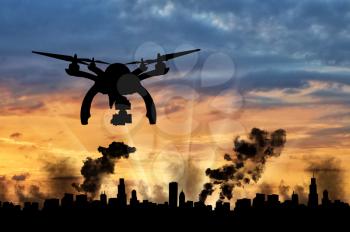 Silhouette flying reconnaissance drone over the city in smoke. Concept of military intelligence and information