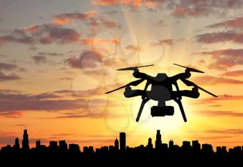 Silhouette flying drones over city. Concept of intelligence and information