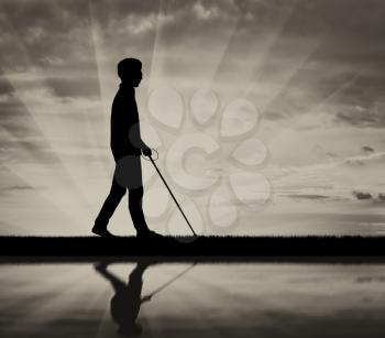 Blind man with cane disabled near water and reflection on black background white. Concept help blind disabilities