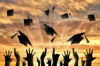 Graduates sunset throwing graduate cap joy. concept of education