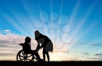 Disabled child in wheelchair crying and his mother day. Concept of disability