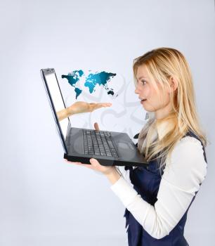 Business woman holding a laptop and tourism advertising in the world. The concept of tourism and Journey