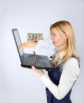 Concept of finance and banking. Hand with money out of laptop offers money to a woman