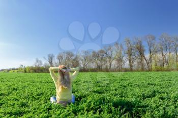 Concept of emotions and feelings. Happy woman on the green grass in the meadow