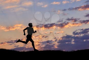 Silhouette of man runner at sunset. The concept of sport and recreation
