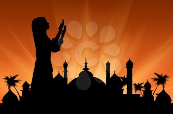 Concept of the Islamic religion. Silhouette of praying woman against the backdrop of the town hall at sunset