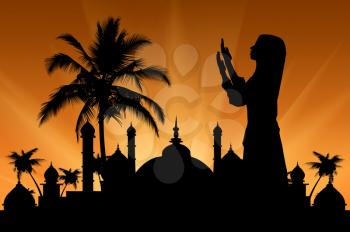 Concept of the Islamic religion. Silhouette of praying woman against the backdrop of the town hall at sunset