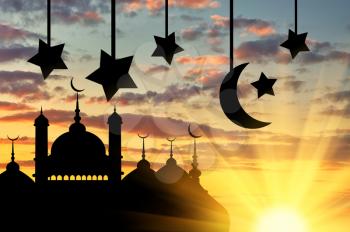 Concept of the Islamic religion. Silhouette of the town hall at sunset in the rays of light