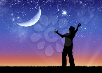 Concept of success. Silhouette of a happy man on the background of the starry sky and the moon