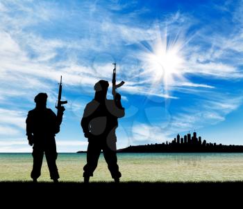 Concept of a terrorist attack. Silhouette of terrorists with a rifle on a background of the city